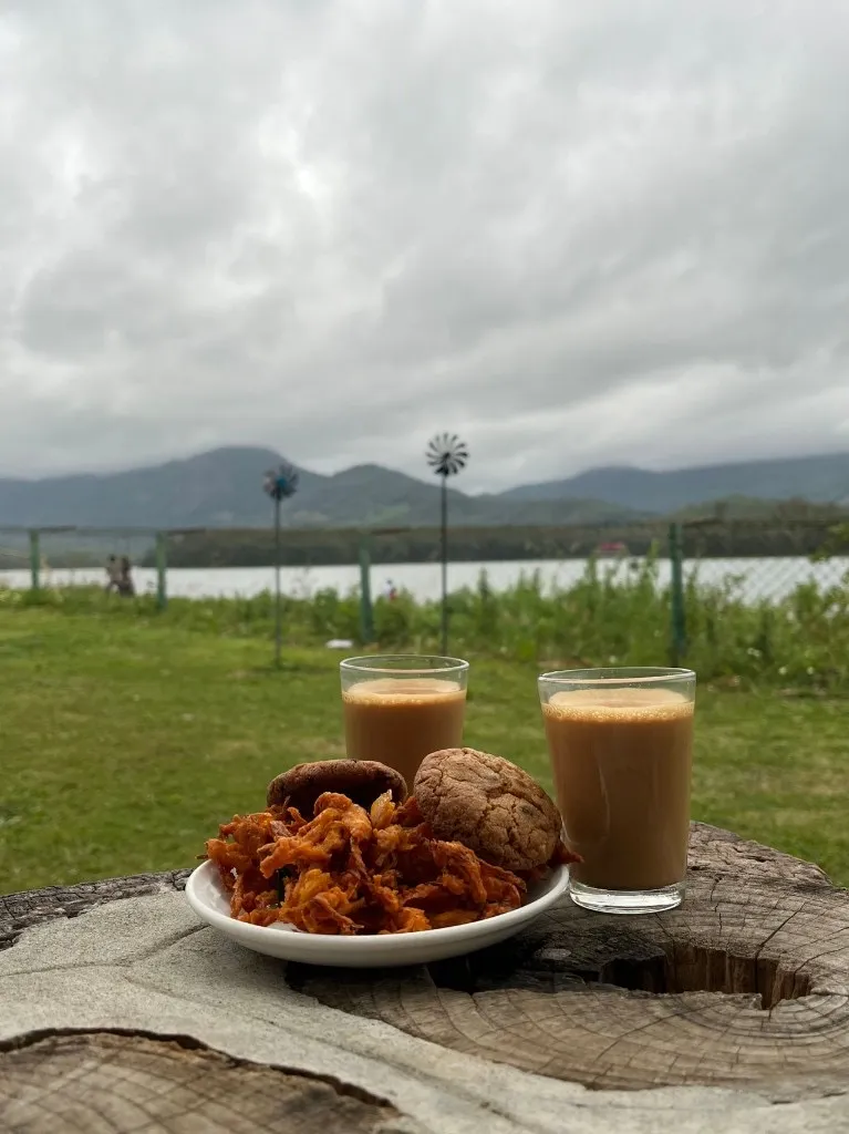 Cutting chai in glasses with onion pakoras - chai weather