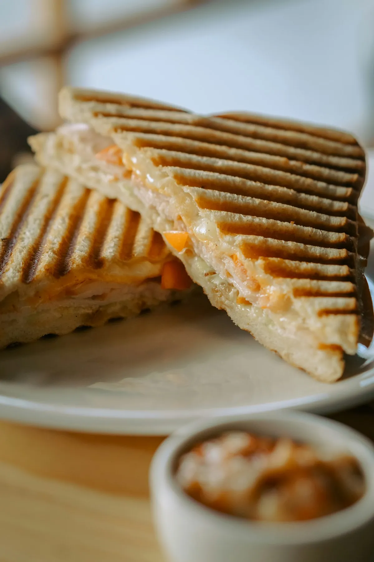 Grilled sandwich cut in half, served with chutney